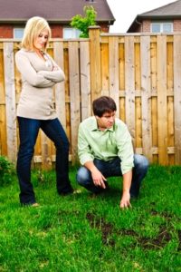 couple inspecting their lawn