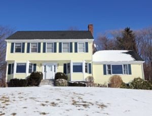 House with snow on the ground and roof