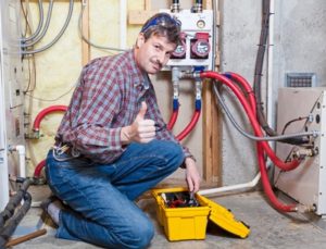 Handyman with toolbox working in a basement