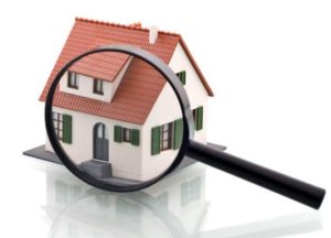 image of magnifying glass over miniature house